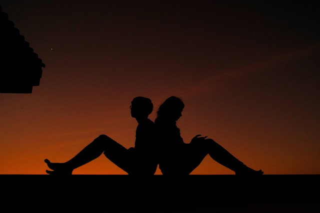 Two people holding hands in support
