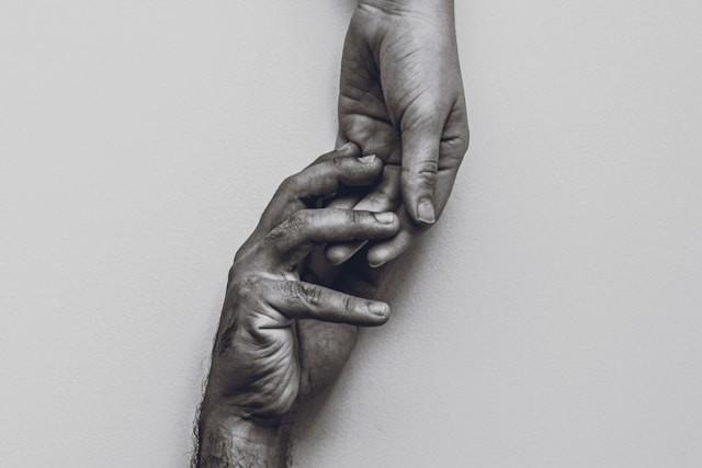 Close-up of two hands gently touching